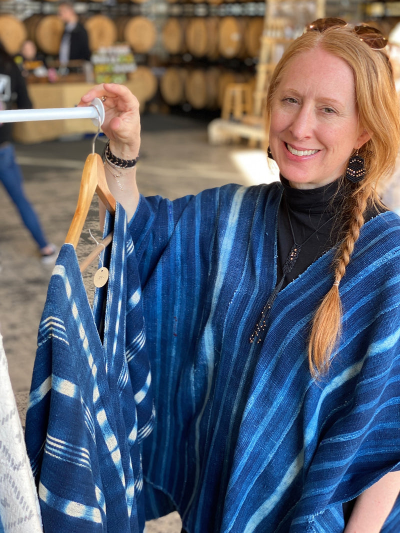 CORDA Founder, Kelli Ronci wearing upcycled Indigo Ponchos that are created from Woven African Mudcloth